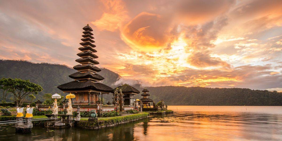 Templo Ulun Danu Beratan junto al lago Bratan y las montañas al atardecer